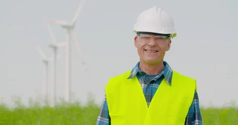Technology successful engineer against windmills Stock Footage 124708690
