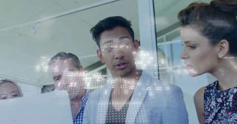 Technology team analyzing data in modern office, showcasing floating binary code Stock Footage 309144596
