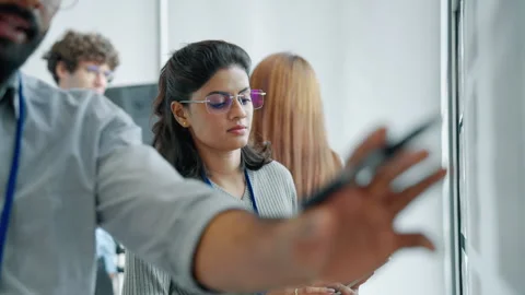 Technology Team Collaborating During Engineering Presentation in Modern Office Stock Footage 348336274