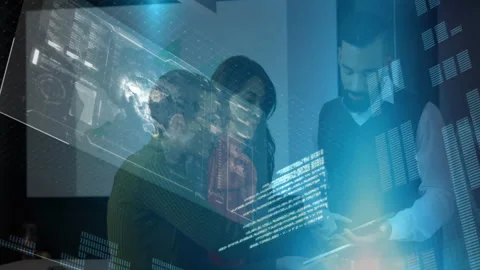 Technology team collaborating in office around laptop projecting code and 3D Stock Footage 307453288