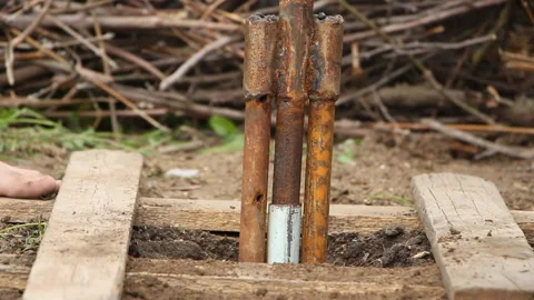 Technology. two men drilled a water well with an improvised drilling rig Stock Footage 107941841