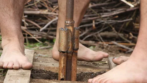 Technology. two men drilled a water well with an improvised drilling rig Stock Footage 108320629