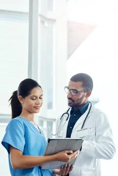 Technology will simplify the diagnosis process. two young doctors using a Stock Photos