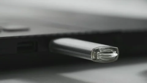 Technology, woman hand includes a flash drive for data transfer in a laptop, red Stock Footage 240858763