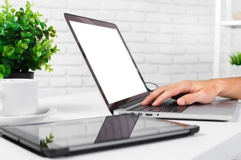 Technology workspace featuring a laptop, tablet, and coffee, ideal for Stock Photos