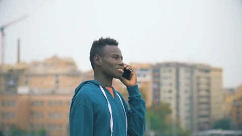 Technology,device,communication. American african man talking by phone Stock-Footage 98238587