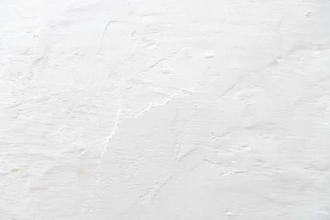 The tecture of a plastered wall whitewashed with a fringe. Stock Photos