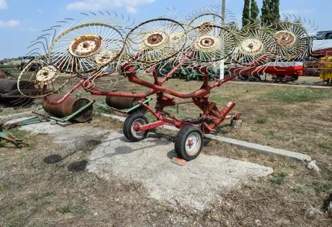 Tedder on trailer for tractor. The machine for gathering hay. Stock Photos