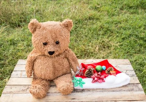 Teddy bear and christmas decoration on wooden table Stock Photos