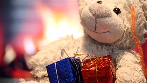 Teddy bear and gift boxes in front of the fireplace Stock Footage 145709665
