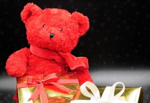 Teddy bear and gift boxes Stock Photos