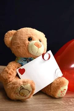 Teddy bear and white envelope with a heart. Valentine's Day gift Stock Photos
