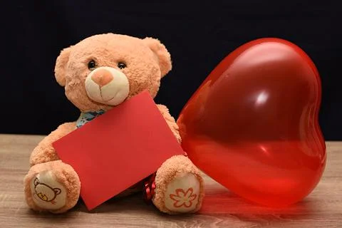 Teddy bear and white envelope with a heart. Valentine's Day gift Stock Photos