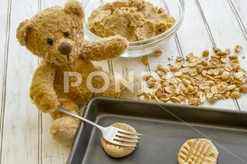 Teddy bear baking cookies Stock Photos