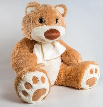 Teddy bear with a bow on a white background. Soft children's toy. Foto stock