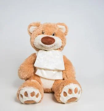 Teddy bear with a bow on a white background. Soft children's toy. Fotos de archivo