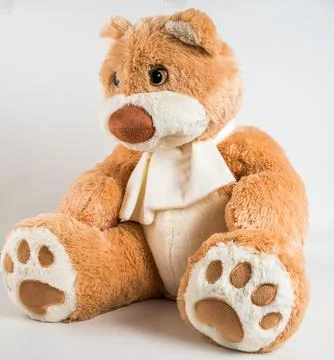 Teddy bear with a bow on a white background. Soft children's toy. Stock Photos