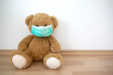 Teddy bear with face mask Stock Photos