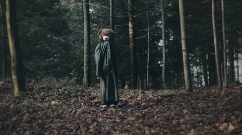 Teddy bear in a forest. Child disguised as teddy bear in a leather coat. Stock Footage 45904971