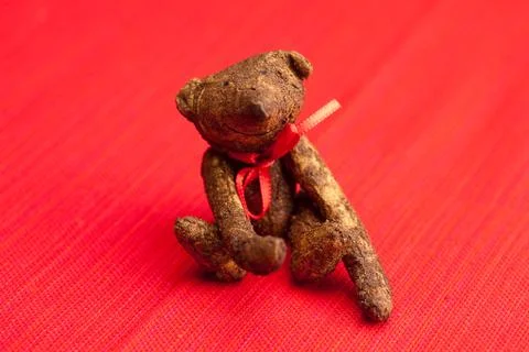 Teddy bear  handmade on a red background Stock Photos