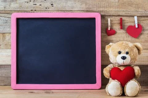 Teddy bear with heart sharp and black board Stock Photos