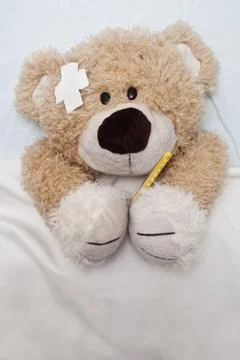 Teddy Bear Laying in Bed Stock Photos