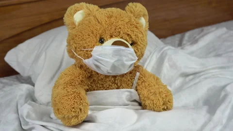 A teddy bear measures the temperature with a mercury thermometer. The doctor Stock Footage 131009274