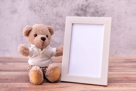 Teddy bear with Picture frame on table wooden. Valentine's Day celebration Stock Photos