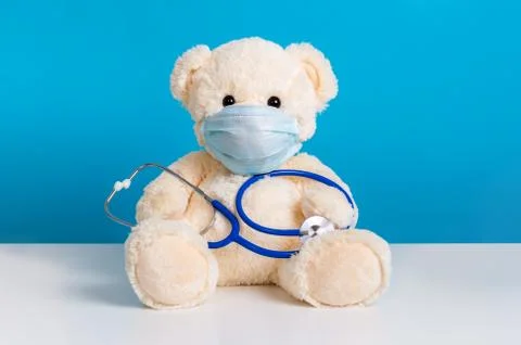 Teddy bear with protective medical mask and stethoscope. Concept of illness,  Stock Photos