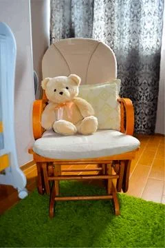 Teddy bear in rocking chair - vector EPS10 Stock Illustration