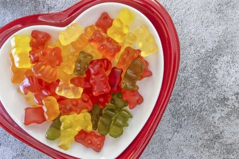 Teddy bear shaped jelly beans on a heart shaped plate Stock Photos