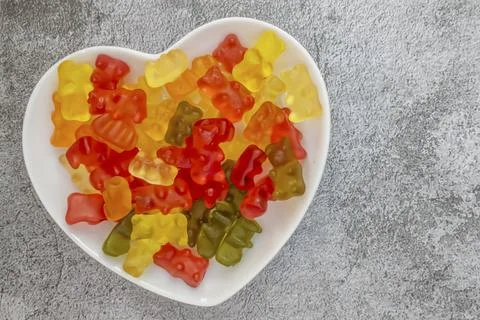 Teddy bear shaped jelly beans on a heart shaped plate Stock Photos