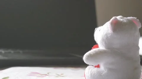 Teddy bear sitting in front of laptop computer device. Still Life. Child usin Stock Footage 130429863