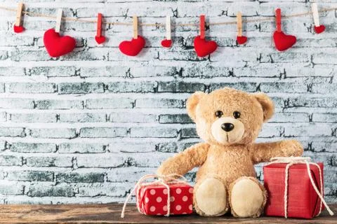 Teddy bear sitting with gift box Stock Photos