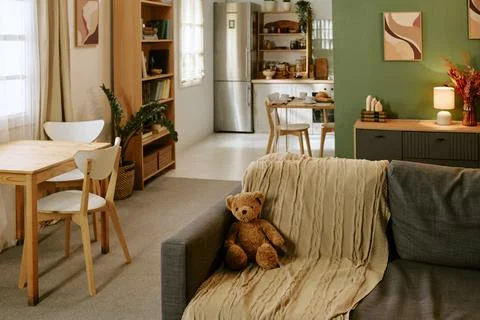 Teddy Bear Sitting on Sofa in Cozy Apartment Interior for Family Lifestyle Stock Photos