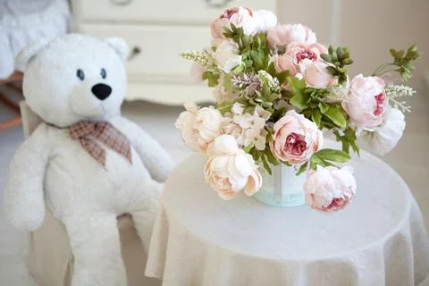 Teddy bear is sitting at the table Stock Photos