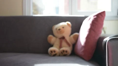 Teddy bear on sofa and some dusty air 스톡 동영상 180699132