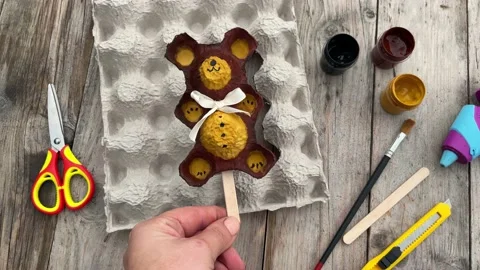 A teddy bear on a stick made from an egg tray. Stock Footage 219719605