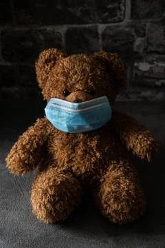 Teddy bear with surgical mask in dramatic light. 写真素材