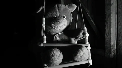 Teddy bear swinging on a swing, black and white Stock Footage 120247129