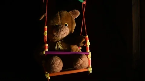 Teddy bear swinging on a swing Stock Footage 120247178
