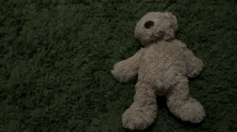 Teddy bear toy on a floor gets kicked Stock Footage 47275972