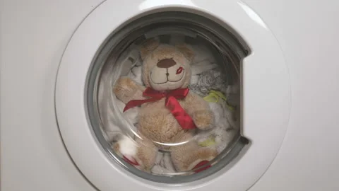 Teddy bear washes in the washing machine. Stock Footage 128653747