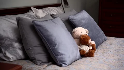 Teddy Bears on the double, grey bed. Close up view. Luxury bedroom. Toys Stock Footage 273556294