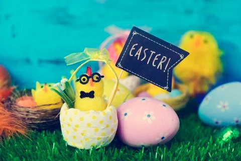 Teddy chick with a signboard with the word easter Stock Photos