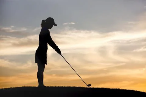 Teeing up at sunset. Stock Photos
