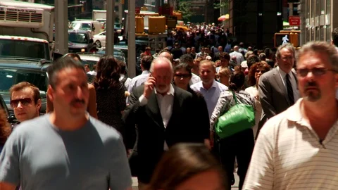 Teeming city street with man on cel phone approaching Stock Footage 111327199