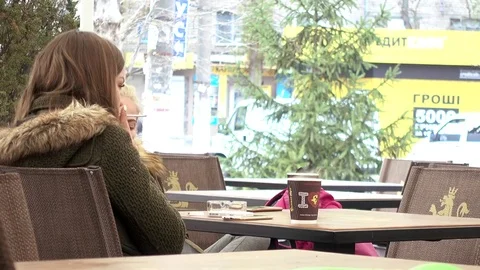 Teen Age Girl Smoking Cigarette Sitting On A Cafe Table Stock Footage