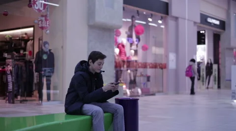 Teen on a bench and playing phone Video stock 59559797