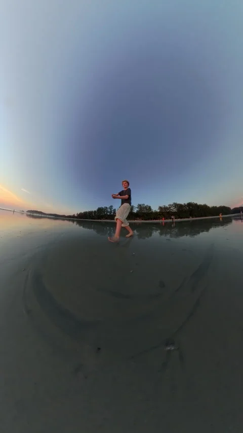 Teen Boy At The Beach In Tiny Planet Perspective During Sunset Stock Footage 306783774